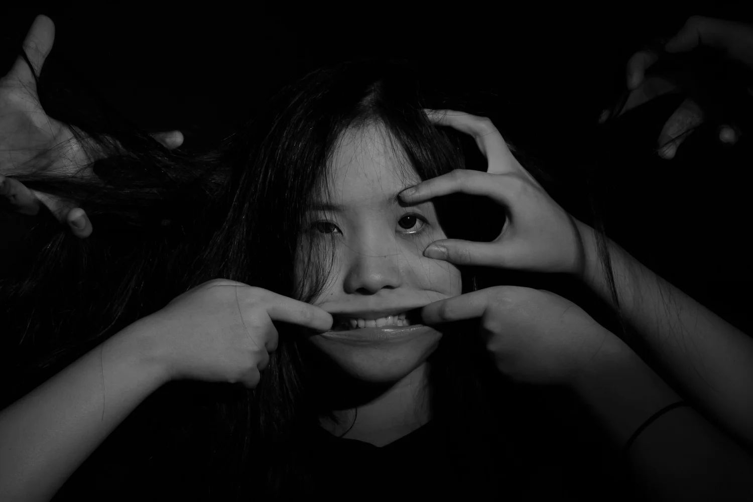 Black and white portrait of a woman pulling a face